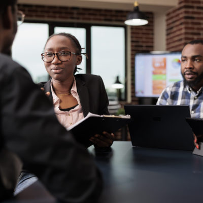 Colleagues team working on company paperwork Colleagues team working on company paperwork, doig teamwork to analyze documents and online research information. Planning corporate presentation with data charts, job collaboration.