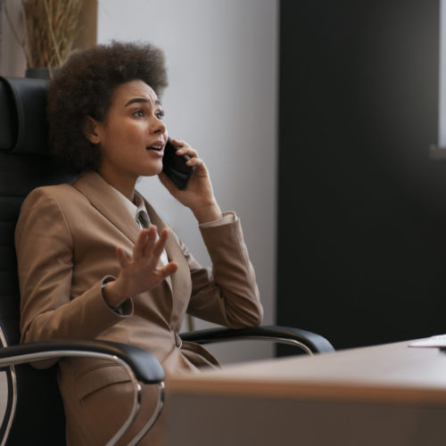 medium-shot-female-economist-holding-smartphone_50-scaled-500x500